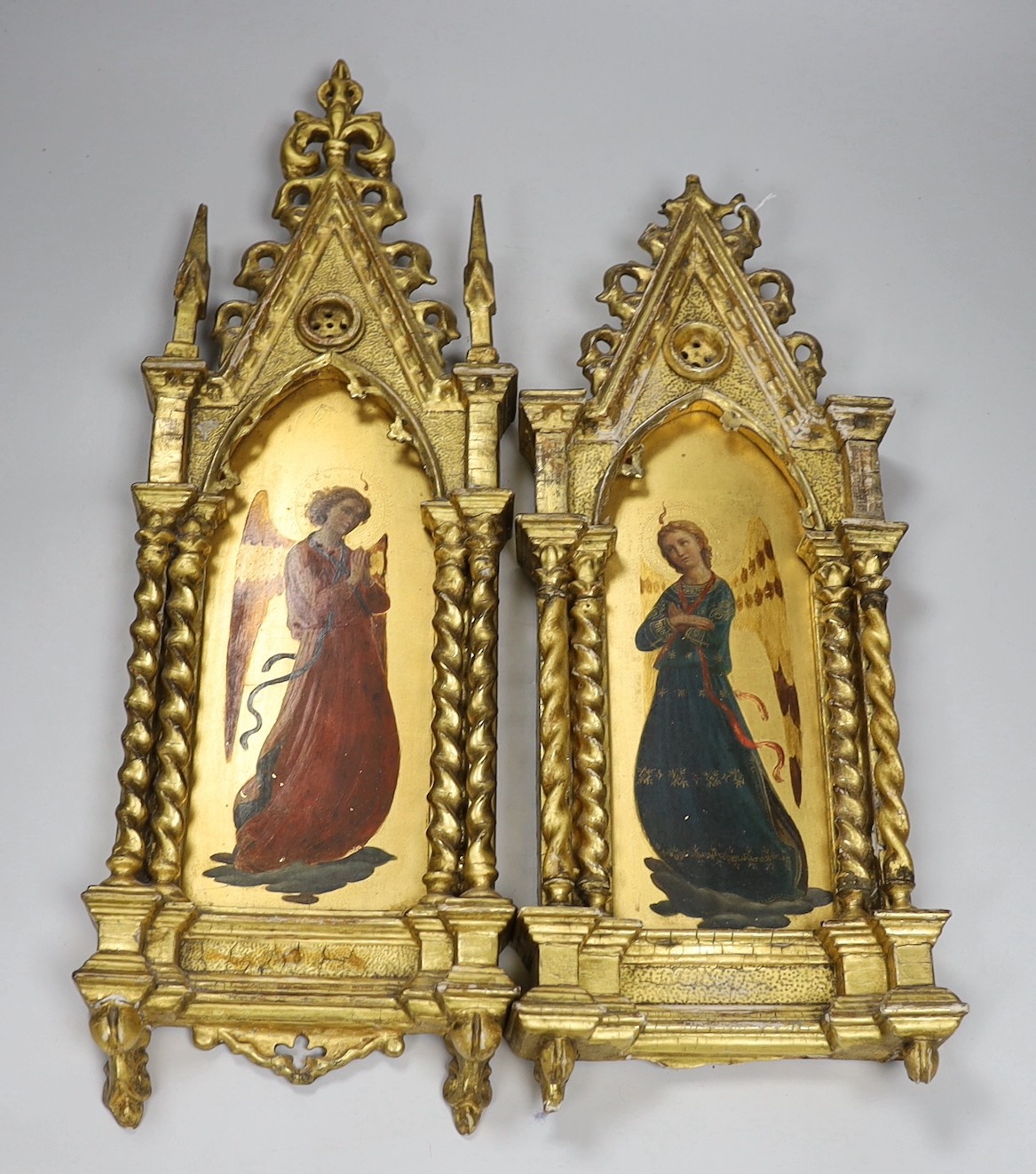 Manner of Fra Angelico, late 19th century, a pair of oils and gilt on panel, Archangels, mounted in ornate carved gilt wood frames (one a.f), 54 x 18cm total